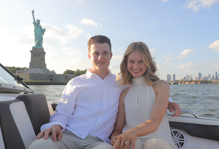 photo of Joe of Village Home Cleaning in New York City with the Statue of Liberty and his wife. Village Home Cleaning provides house cleaning services in Manhattan.